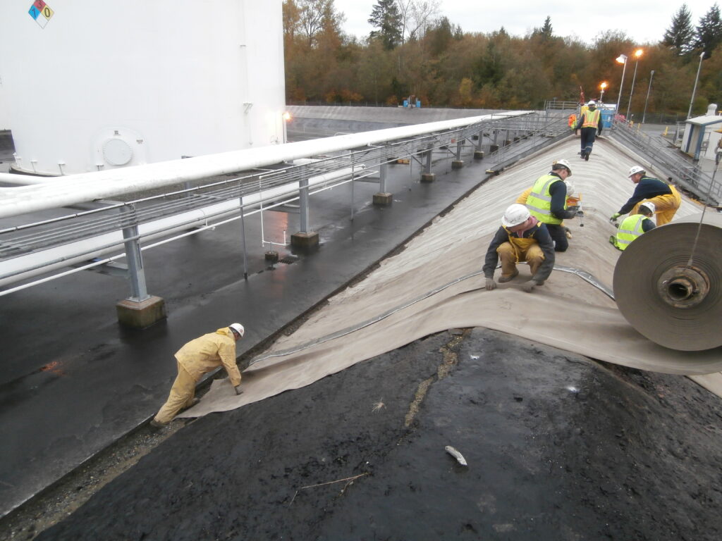 Image of concrete canvas being installed for bund lining at a refinery site.