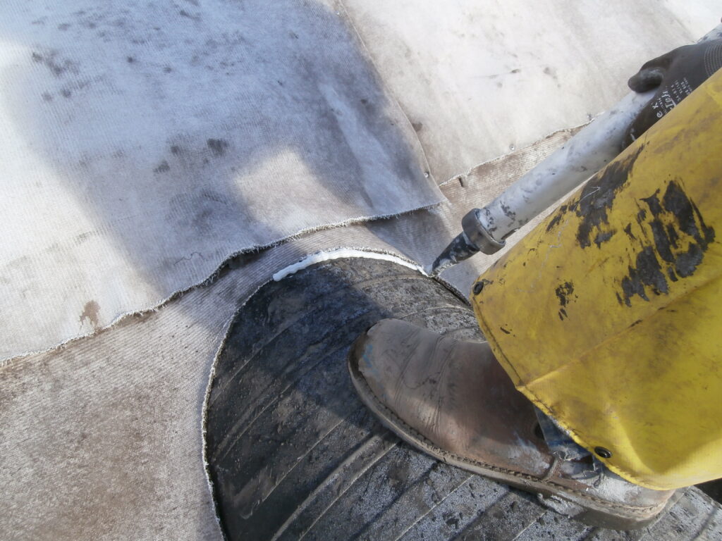 Close-up image of concrete canvas being applied as a bund lining at a refinery site.