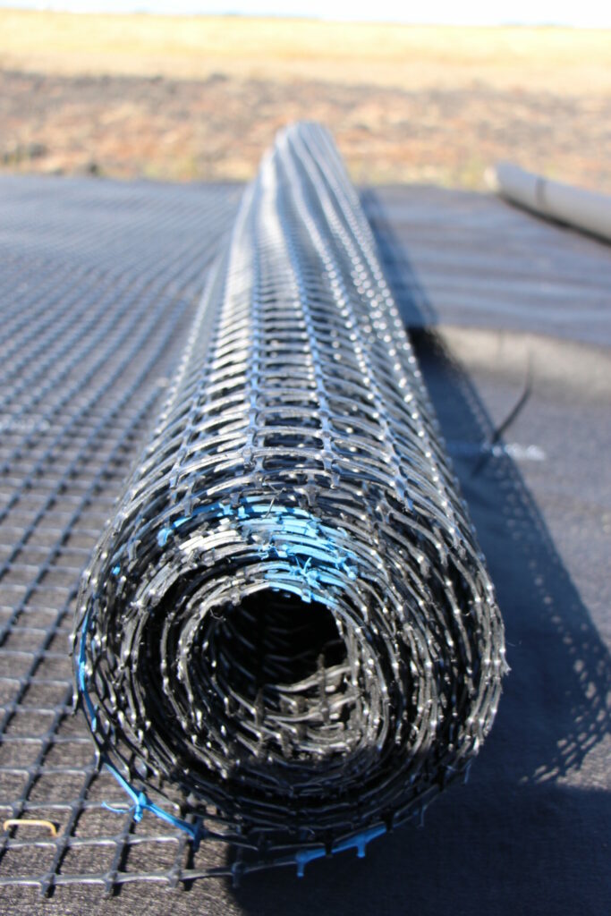 Close up image of a roll of Titan Earth Grid being applied for base reinforcement. 